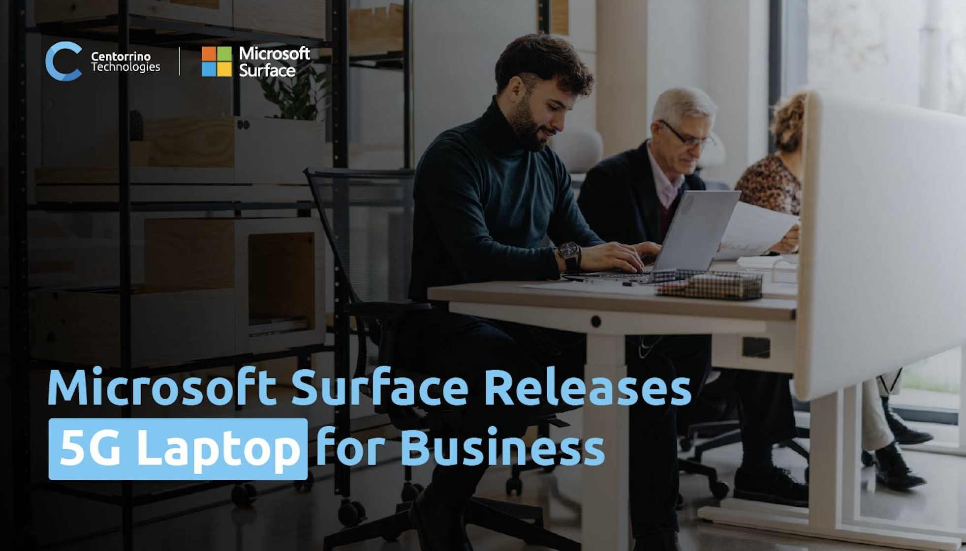 Text: Microsoft Surface Releases 5G Laptop for Business. Image shows 3 colleagues at a desk working off their Microsoft Surface 5g Laptops.